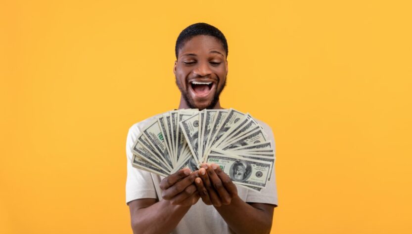 overjoyed-black-guy-with-dollar-banknotes-key-to-success-online-sports-betting-live-singapore-malaysia